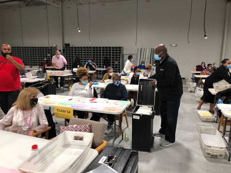 Gwinnett County elections officials are re-opening the secured ballot boxes and counting is about to resume. Credit: J. Scott Trubey / AJC