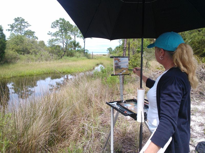 A painter works in the elements to capture the natural beauty around Port St. Joe, Fla., at the Forgotten Coast en Plein Air event held at various points along this sleepy stretch of the Panhandle. CONTRIBUTED BY BLAKE GUTHRIE