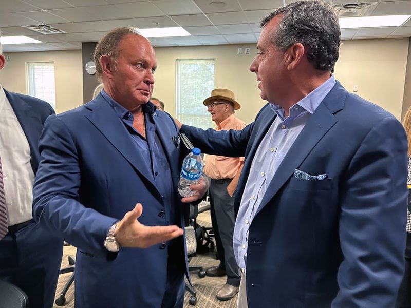 TV and film studio owner and real estate developer John Raulet (right) greets Gray Television and Assembly Studio Chief Executive Hilton Howell at a legislative hearing about the state's TV and film tax credits Oct. 4, 2023 in Athens at Athens Technical College. RODNEY HO/rho@ajc.com