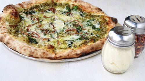 Genuine Pizza’s kale pie is made with caramelized onion, chile flakes, and fontina and Parmesan cheeses. CONTRIBUTED BY GENUINE PIZZA