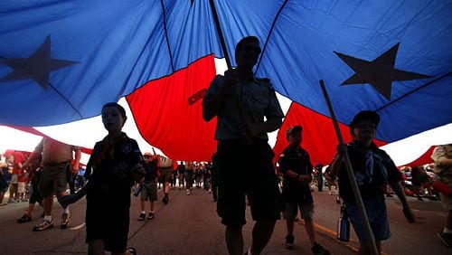 Boy Scouts of America and Cub Scout troops carry a large American flag during the LibertyFest Fourth of July parade in Edmond, Okla.