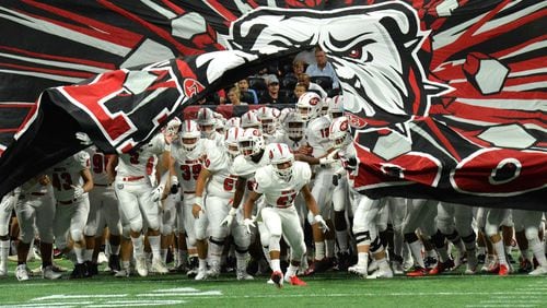 North Gwinnett football players run onto the Mercedes-Benz Stadium field ahead of their Corky Kell matchup against Brookwood Saturday, Aug. 18, 2018, in Atlanta.