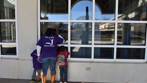 Visitors peek into a window at the visitor’s center after they found out sites at the Martin Luther King Jr. National Historic Park were closed after Congress failed to avert a government shutdown on Saturday, January 20, 2018. Many federal government services ground to halt and some historic attractions - including Martin Luther King Jr.'s childhood home - were closed in Georgia on Saturday.
