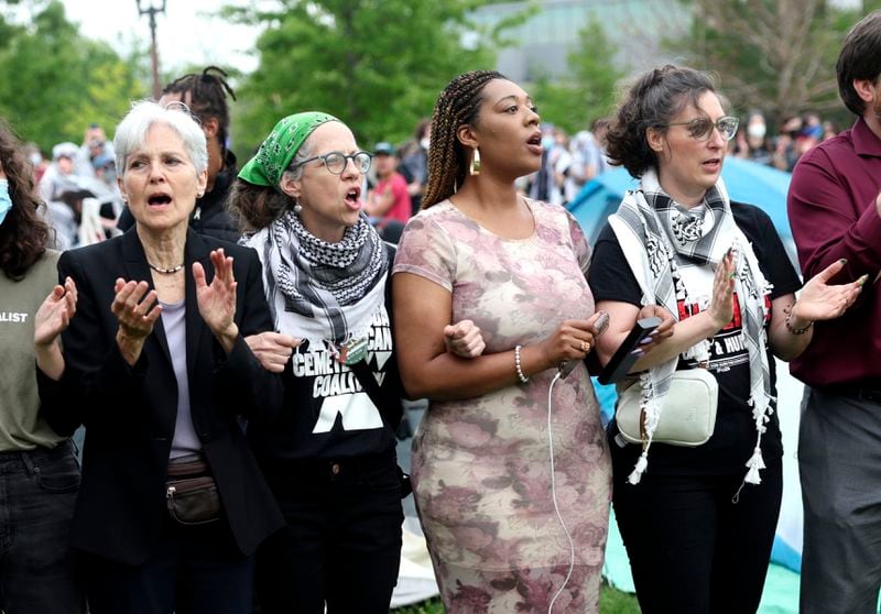 Green Party presidential candidate Jill Stein, left, links arms with others, including Alderwoman Alisha Sonnier, second from right, and Aldermanic President Megan Green, right, while surrounding pro-Palestinian protesters as police show up to their encampment on the campus of Washington University, Saturday, April 27, 2024, in St. Louis, Mo. Dozens were arrested during the protest. (Christine Tannous/St. Louis Post-Dispatch via AP)