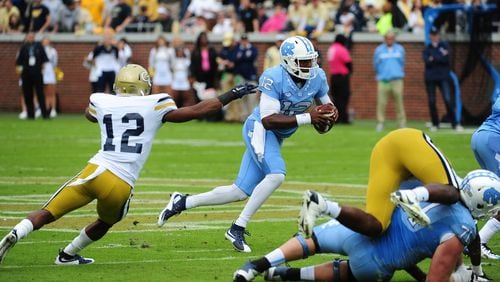 ATLANTA, GA - OCTOBER 3: Marquise Williams #12 of the North Carolina Tar Heels scrambles away from Demond Smith #12 of the Georgia Tech Yellow Jackets on October 3, 2015 in Atlanta, Georgia. Photo by Scott Cunningham/Getty Images)