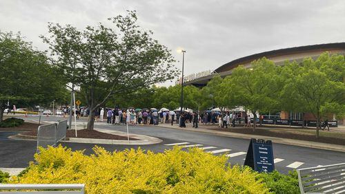 Guests line up outside Gas South Arena in Gwinnett County for Emory University's 2024 undergraduate commencement ceremony. (Josh Reyes/josh.reyes@ajc.com)