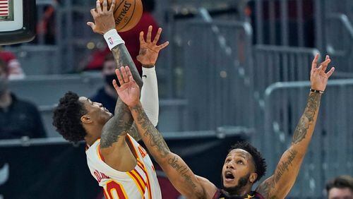 Cleveland Cavaliers' Lamar Stevens (8) and Atlanta Hawks' John Collins (20) battle for a loose ball in the first half Tuesday, Feb. 23, 2021, in Cleveland. Stevens was called for the foul. (Tony Dejak/AP)