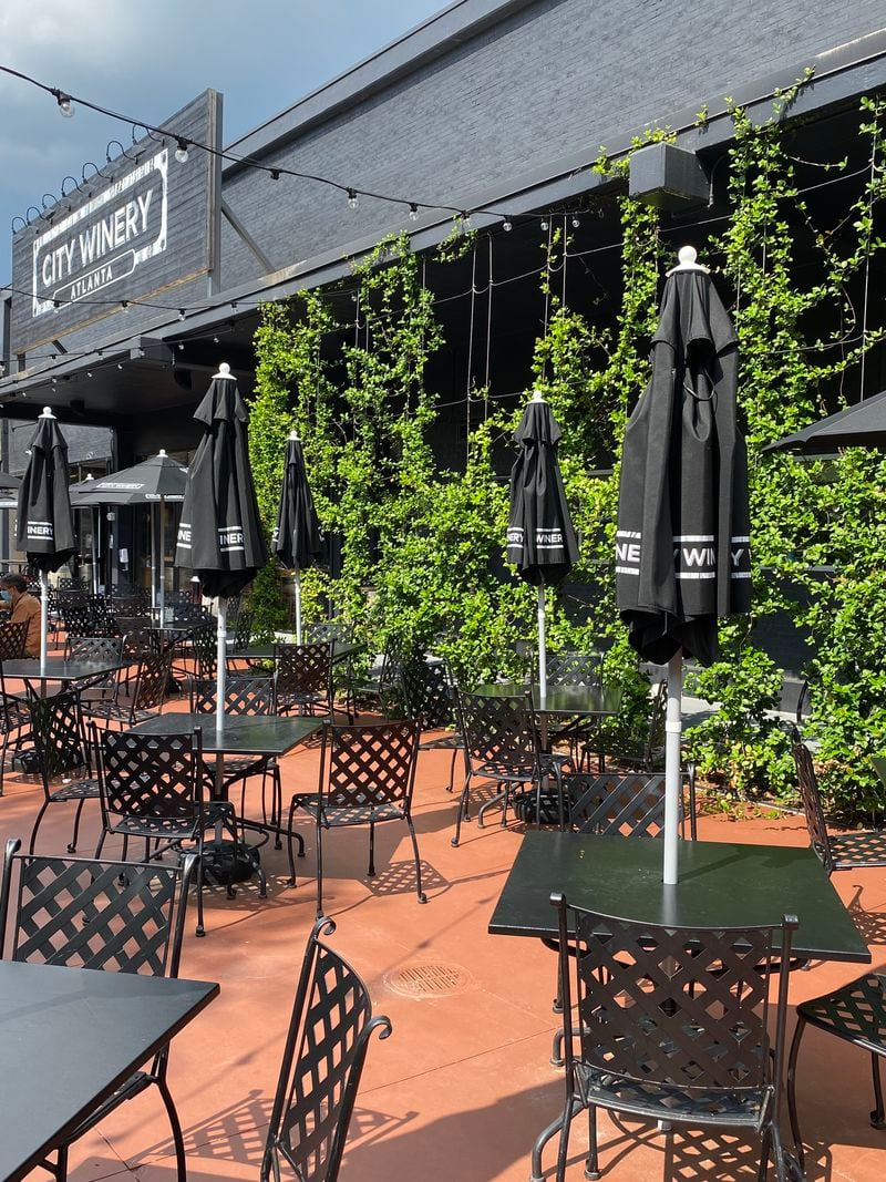 The May reopening of City Winery brought a revamped design with plenty of outdoor upgrades that include umbrella tables and plush lounge seating around a fire pit. (Ligaya Figueras / ligaya.figueras@ajc.com)