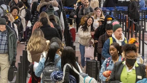 Early morning travelers make their way through the security line at Hartsfield-Jackson International Airport on Saturday, Dec. 24, 2022. (Steve Schaefer/Atlanta Journal-Constitution/TNS)