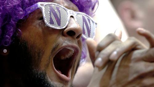 A Northwestern fan cheers for his team before an NCAA college basketball game between Purdue and Northwestern Sunday, March 5, 2017, in Evanston, Ill. (AP Photo/Nam Y. Huh)