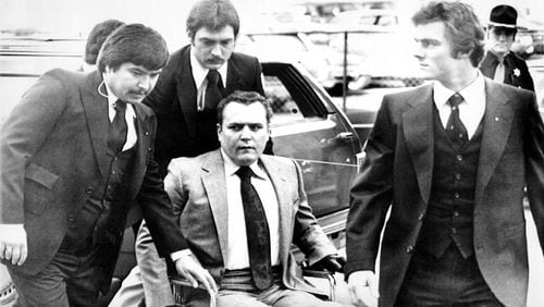 Hustler magazine publisher Larry Flynt is surrounded by heavy security as he arrives March 19, 1979, at the Fulton County Courthouse for the start of his trial on obscenity charges. In June 1984, Joseph Paul Franklin, a self-avowed white supremacist, was indicted by a Gwinnett County grand jury and charged with aggravated assault in the 1978 shootings of Larry Flynt (above) and Gene Reeves (not pictured). Flynt was left paralyzed from the waist down by the attack; Reeves recovered and went on to become a judge in Gwinnett County. Franklin, a serial killer who may have killed up to 22 people, was executed by lethal injection in Missouri in November 2013. Reeves died in July 2015 at age 85.