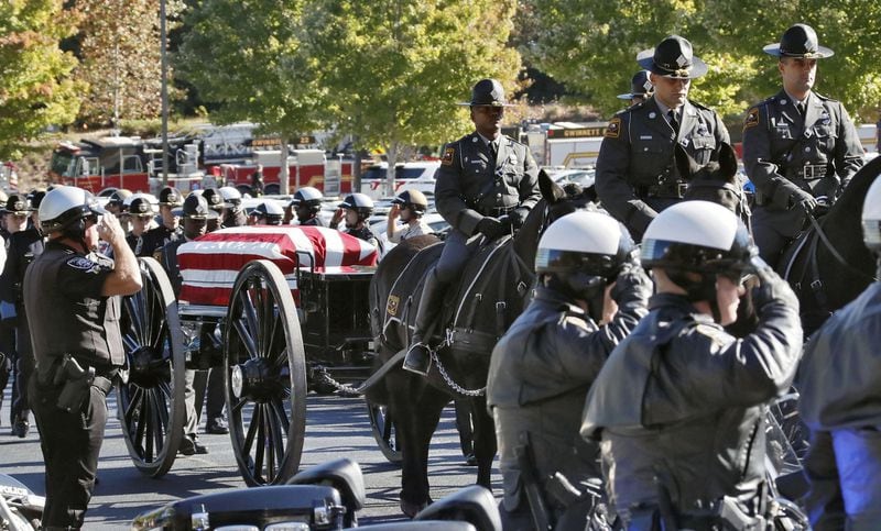A caisson carrying the casket processes through a motorcycle honor guard to the church. Funeral services were held Oct. 24 for Gwinnett Police Officer Antwan Toney at 12Stone church in Lawrenceville.BOB ANDRES / BANDRES@AJC.COM