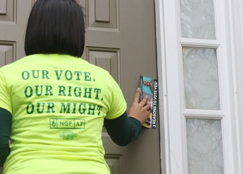Michelle Sanchez with the New Georgia Project Action Fund leaves information in support of the Gwinnett County MARTA referendum while canvassing on February 22, 2019 in Norcross. 