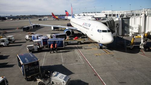 SEATTLE, WA - MARCH 15: A ground crew prepares to unload luggage from an arriving Delta Airlines flight at the Seattle-Tacoma International Airport on March 15, 2020 in Seattle, Washington. (Photo by John Moore/Getty Images) (John Moore/Getty Images)