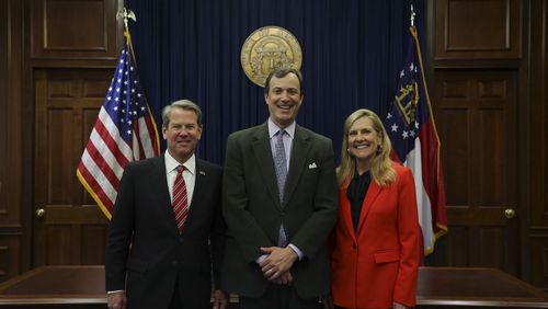 Gov. Brian Kemp and his wife Marty pose for a picture with Trey Kilpatrick, his chief of staff. 