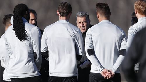 Atlanta United FC head coach Gerardo “Tata” Martino talks with his players during a soccer training session Thursday, Feb. 16, 2017 in Flowery Branch, Ga. Martino isn’t backing down from the high expectations that go with being the MLS expansion Atlanta United coach. As the former coach of the Argentina and Paraguay national teams, Martino knows more than a little about trying to satisfy a demanding fan base. (AP Photo/John Bazemore)