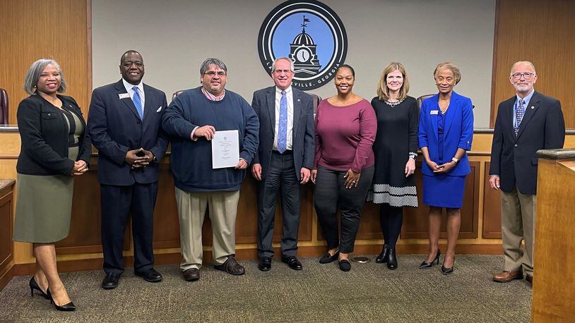 Lawrenceville staff is recognized for their contribution toward the Distinguished Budget Presentation Award for the fiscal year 2023 budget.  Pictured L-R are Councilwoman Victoria Jones, Councilman Austin Thompson, Keith Lee, Chief Financial Officer, Mayor David Still, Budget Officer Shereese Durham, Community Relations Director & Chief Communications Officer Melissa Hardegree, Councilwoman Marlene Taylor-Crawford, and Councilman Glenn Martin. COURTESY CITY OF LAWRENCEVILLE