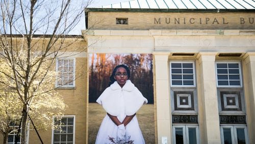 Ariel McCullough, dressed in her cotillion outfit, is featured in the photo mural installation “Seeing Newnan.” Contributed by Mary Beth Meehan