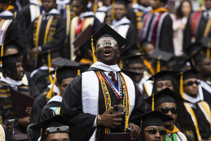Graduate Hasani Comer cheers for a friend during the Morehouse College commencement ceremony on Sunday, May 21, 2023, on Century Campus in Atlanta. The graduation marked Morehouse College's 139th commencement program. CHRISTINA MATACOTTA FOR THE ATLANTA JOURNAL-CONSTITUTION