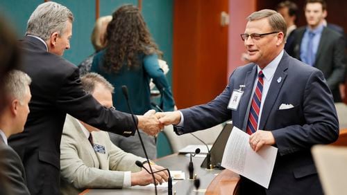 2/8/18 - Atlanta - Mike Griffin (right), lobbyist for the Georgia Baptist Mission Board, greets members of the committee before a committee hearing on a bill that would permit adoption agencies to turn away same-sex couples.  The full Senate Judiciary Committee, chaired by Sen. Jesse Stone (left) could vote Tuesday on the bill. BOB ANDRES  /BANDRES@AJC.COM