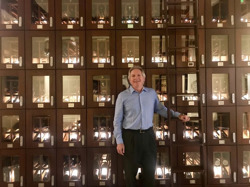 Vine Vault CEO Elton Potts stands near the trophy case lockers in the lobby of the facility located in Buckhead. The company also operates a facility in Austin, Texas. LIGAYA FIGUERAS / LFIGUERAS@AJC.COM
