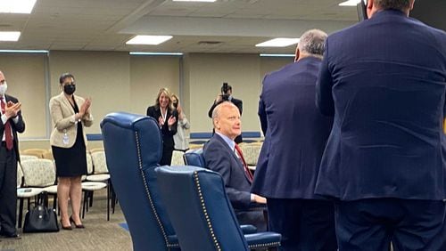 University System of Georgia Chancellor Steve Wrigley, seated, gets a standing ovation from state Board of Regents members and staff during his final scheduled meeting as chancellor on Tuesday, May 11, 2021. Wrigley plans to retire at the end of June. (Eric Stirgus / estirgus@ajc.com)
