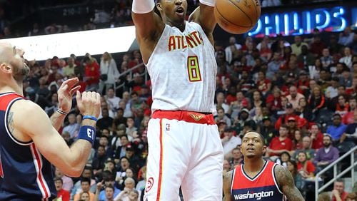Dwight Howard of the Hawks dunks for two over Marcin Gortat and Bradley Beal of the Wizards in Game 4 of a first-round playoff series on Monday, April 24, 2017, in Atlanta. Curtis Compton/ccompton@ajc.com