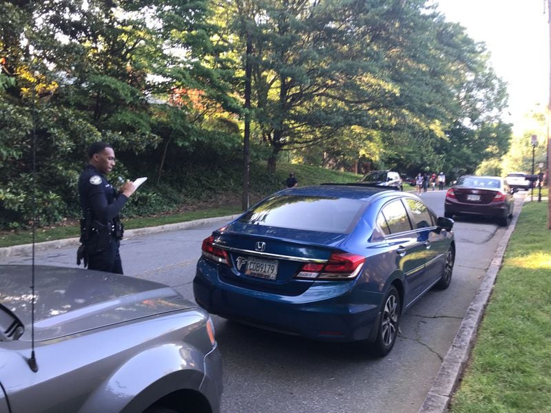 Police writing tickets for cars lining side streets near the Governor's Mansion on Saturday, May 30, 2020. VANESSA MCCRAY / AJC