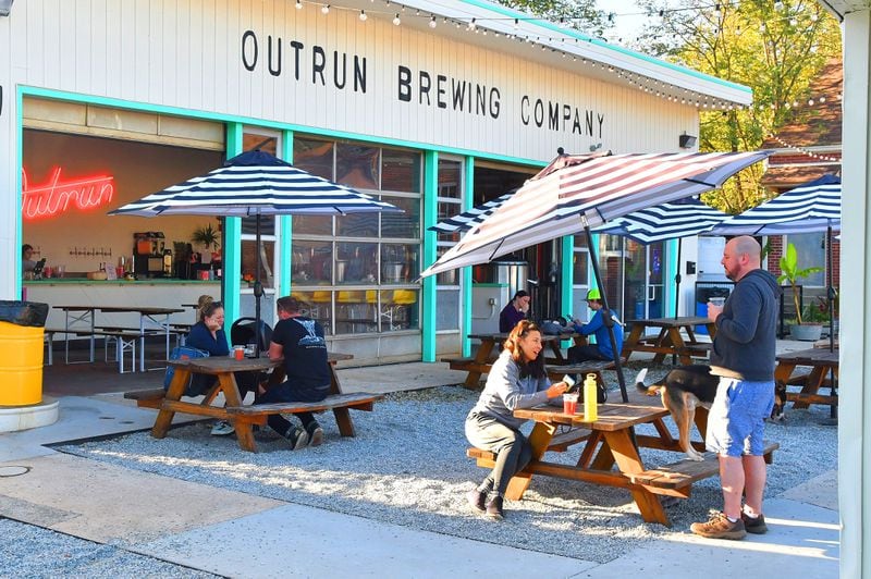 Patrons enjoy a cool late Sunday afternoon recently at Outrun Brewing Co. in Stone Mountain Village. (Chris Hunt for The Atlanta Journal-Constitution)