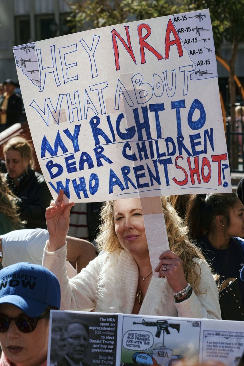 Heidi Ferrer carries a sign and joins protestors against gun violence in Pershing Square Feb. 19 in downtown Los Angeles. Hundreds of sign-carrying, chanting protesters have converged on a downtown Los Angeles park, demanding tougher background checks and other gun-safety measures following the deadly school shooting last week in Florida. (AP Photo/Richard Vogel)