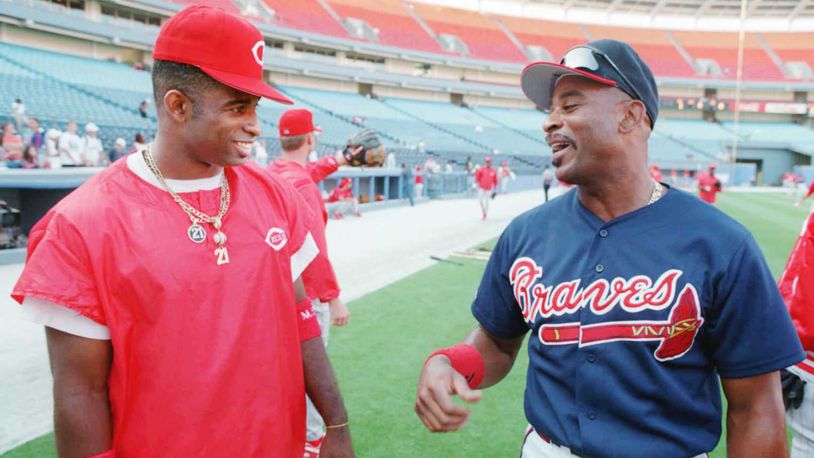 Former Brave Deion Sanders (left) visits with Braves outfielder Dwight Smith before a game Friday, May 12, 1995 at Atlanta-Fulton County Stadium. (Photo by Frank Niemeir/AJC file)