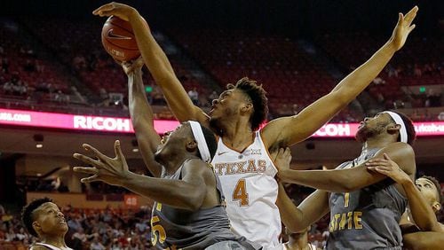 James Banks #4 of the Texas Longhorns blocks a shot by Jimmy Hall #35 of the Kent State Golden Flashes as Adonis De La Rosa #1 of the Kent State Golden looks on at the Frank Erwin Center on December 27, 2016 in Austin, Texas. (Photo by Chris Covatta/Getty Images)