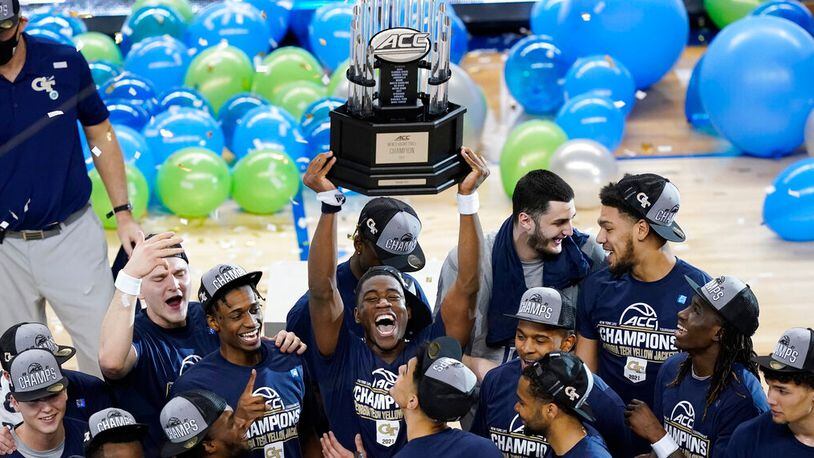 Georgia Tech players hold the trophy as they celebrate their 80-75 win over Florida State in the ACC championship game Saturday, March 13, 2021, in Greensboro, N.C. (Gerry Broome/AP)