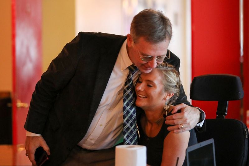Aimee Copeland receives a hug from her father, Andy Copeland, as he arrives at a Feb. 5 board meeting of the Aimee Copeland Foundation. “Both of my parents are my No. 1 supporters,” she says “and my dad plays a very crucial role with the foundation.”