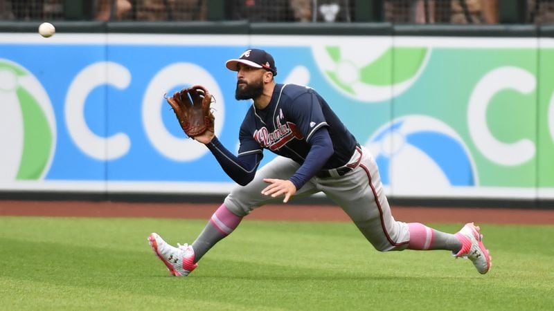 Braves right fielder Nick Markakis makes a diving catch on a line drive hit by Arizona's Wilmer Flores during the fifth inning  May 12, 2019, at Chase Field in Phoenix,.