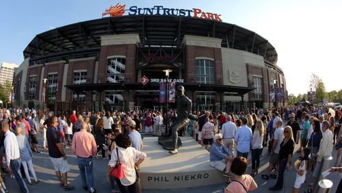 Fans wait to get inside SunTrust Park Friday night for Billy Joel, the first concert held at the baseball stadium. Photo: Robb Cohen Photography & Video