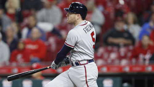 Braves first baseman Freddie Freeman hits a solo home run in the ninth inning  April 24, 2018, against the Cincinnati Reds at Great American Ball Park on in Cincinnati.