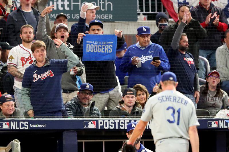 Fans react as Los Angeles Dodgers starting pitcher Max Scherzer (31) is removed from the mound during the fifth inning of Game 2 of the NLCS Sunday, Oct. 17, 2021, at Truist Park in Atlanta. (Curtis Compton / curtis.compton@ajc.com)