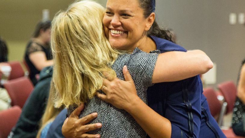 Superintendent Meria Carstarphen hugs a supporter before the Atlanta school board’s special meeting Monday to discuss her contract. PHIL SKINNER