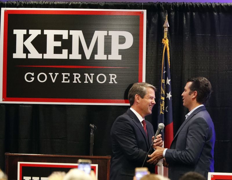 Republican nominee for governor Brian Kemp, left, welcomes Donald Trump Jr on stage during a campaign event this month in Athens. (AP Photo/John Bazemore)