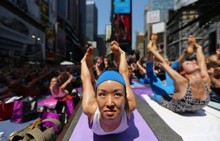 Enthusiasts perform yoga in Times Square to mark summer solstice, June 21, 2013
