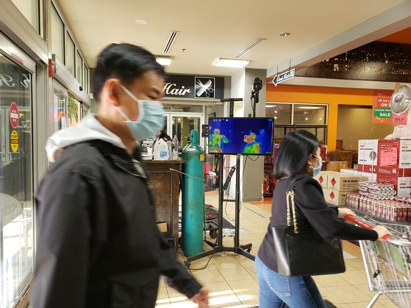 As metro Atlanta approaches a second Chinese New Year in a row impacted by the coronavirus pandemic, area businesses are putting out holiday items. At City Farmers Market on Pleasant Hill Road in Duluth, shoppers entering the store undergo temperature checks. MATT KEMPNER / AJC