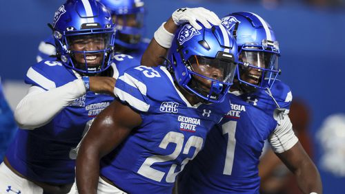 Georgia State running back Marcus Carroll (23, center) celebrates his 12-yard touchdown run with quarterback Darren Grainger, left, and wide receiver Robert Lewis (1) during the second half against Rhode Island at Center Parc Stadium, Thursday, August 31, 2023, in Atlanta. Carroll had a career-high 184 yards and three touchdowns. Georgia State won 42-35. (Jason Getz / Jason.Getz@ajc.com)