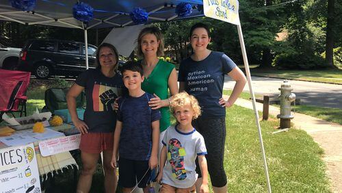 Sen. Elena Parent (center) tweeted about her visit to a lemonade stand in DeKalb County, where the proceeds will be donated to support children in ICE custody.