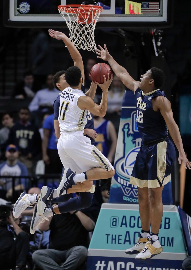  Georgia Tech guard Josh Heath (11) put up a shot against Pittsburgh guard Cameron Johnson (23) and guard Chris Jones (12) during the first half of an NCAA college basketball game in the first round of the ACC tournament, Tuesday, March 7, 2017, in New York. (AP Photo/Julie Jacobson)