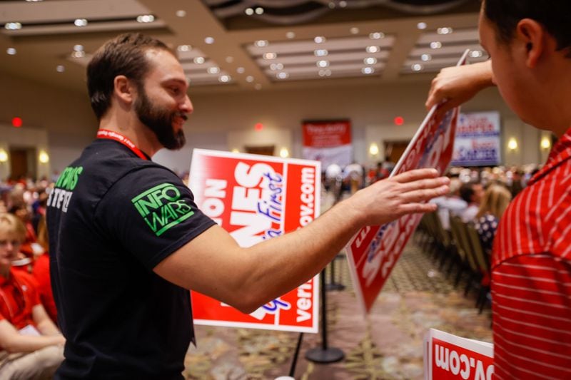 Volunteers with Vernon Jones pass out signs ahead of his speech to delegates at the 2021 Georgia Republican Party Convention. Nathan Posner for The Atlanta Journal-Constitution.