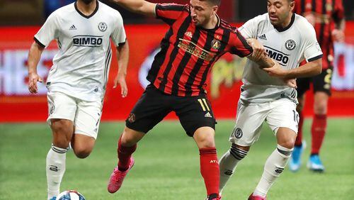October 24, 2019 Atlanta: Atlanta United midfielder Eric Remedi is fouled battling Philadelphia defenders in the Eastern Conference semifinals of the MLS playoffs on Thursday, October 24, 2019, in Atlanta.   Curtis Compton/ccompton@ajc.com
