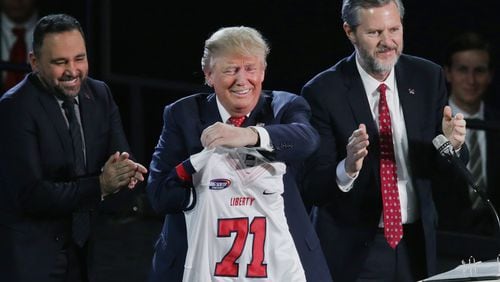 Liberty University President Jerry Falwell, Jr. (right) presents Republican presidential candidate Donald Trump with a sports jersey after he delivered the convocation at the university in Lynchburg, Va., last week. Chip Somodevilla/Getty Images