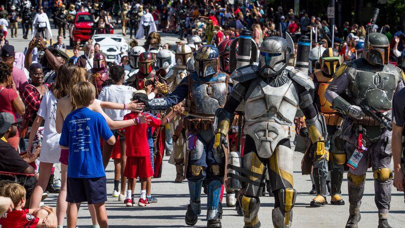 Large crowds gather along Peachtree Street Saturday to watch the Dragon Con parade in 2017. STEVE SCHAEFER / SPECIAL TO THE AJC