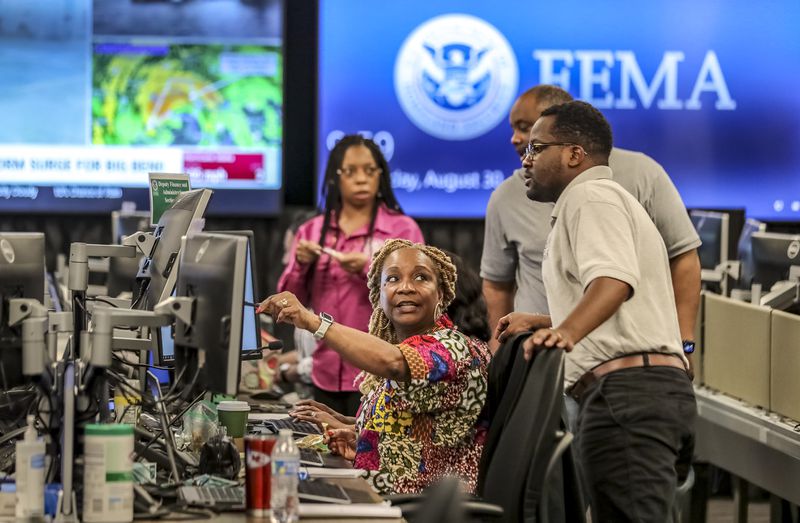 Workers in FEMA's Regional Response Coordination Center in DeKalb County on Aug. 30 prepare for Hurricane Idalia. (John Spink / John.Spink@ajc.com)


